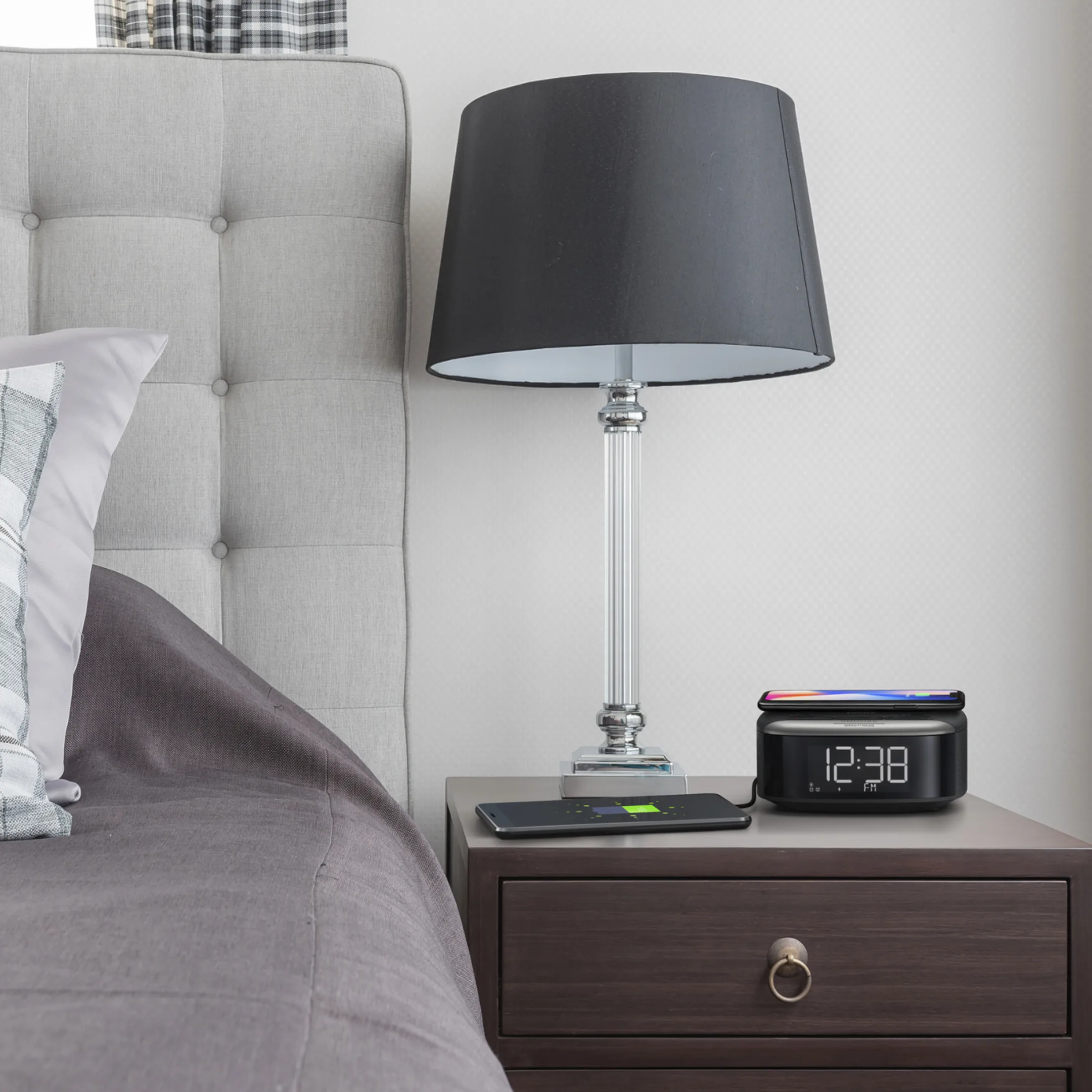 Philips TAR7606 37 Bluetooth clock radio and wireless charger placed on a nightstand in a bedroom setup