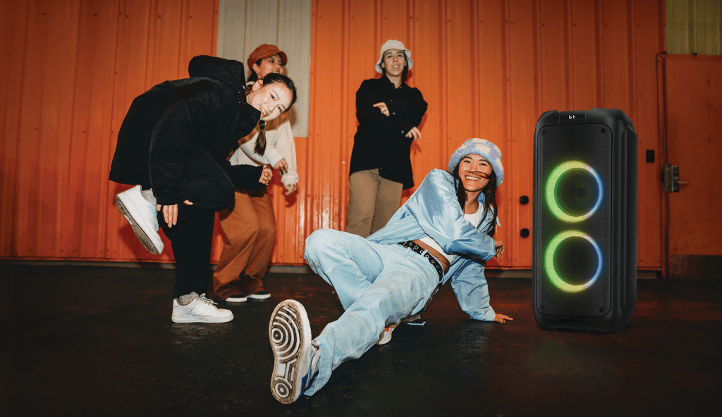 Philips TAX4509 Bluetooth party speaker with dual RGB light rings near street dancers outdoors